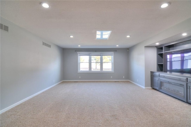 interior space with light carpet, recessed lighting, visible vents, and baseboards