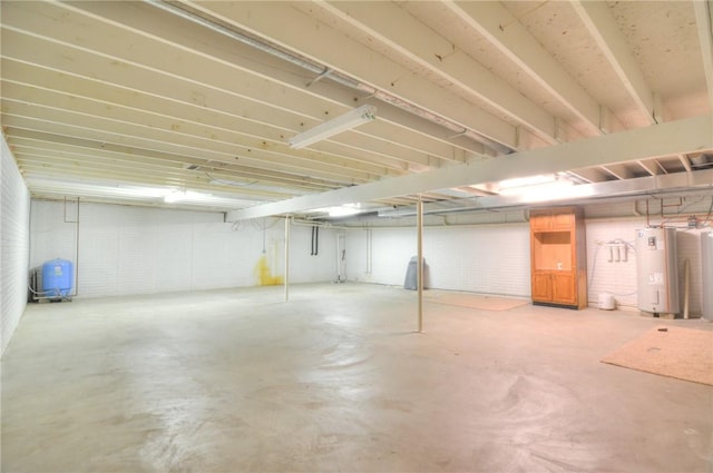 unfinished basement featuring water heater