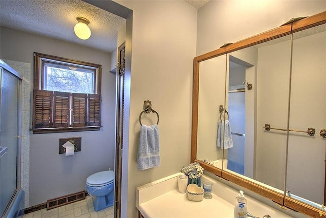 bathroom featuring visible vents, a textured ceiling, and toilet