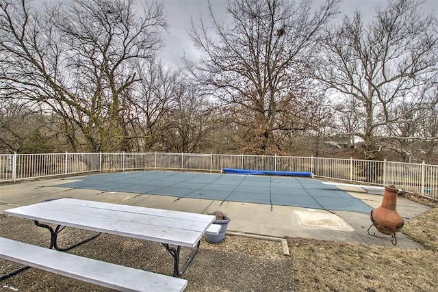 view of pool with a fenced in pool, a patio area, and fence