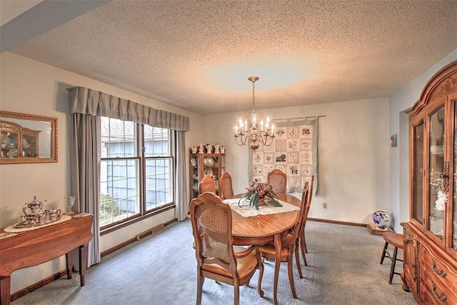 carpeted dining area featuring a chandelier, visible vents, a textured ceiling, and baseboards