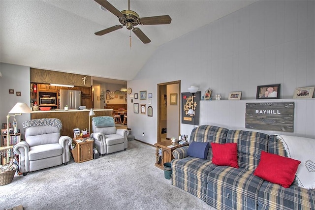 living area featuring wooden walls, a ceiling fan, carpet flooring, a textured ceiling, and high vaulted ceiling