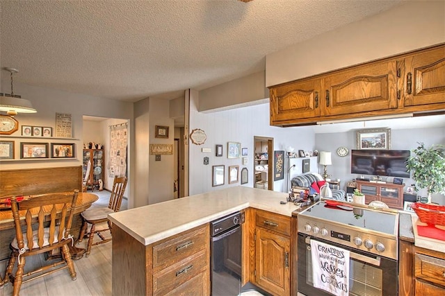 kitchen featuring light countertops, stainless steel electric range, and brown cabinets