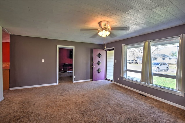 carpeted spare room with ceiling fan and a healthy amount of sunlight