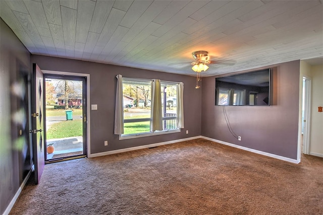 empty room featuring carpet flooring, ceiling fan, and wood ceiling