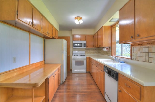 635 E N St, Warrensburg, IL 62573 - kitchen with white appliances, decorative backsplash, wood finished floors, and a sink