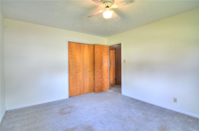 635 E N St, Warrensburg, IL 62573 - unfurnished bedroom featuring carpet floors, a closet, baseboards, and ceiling fan
