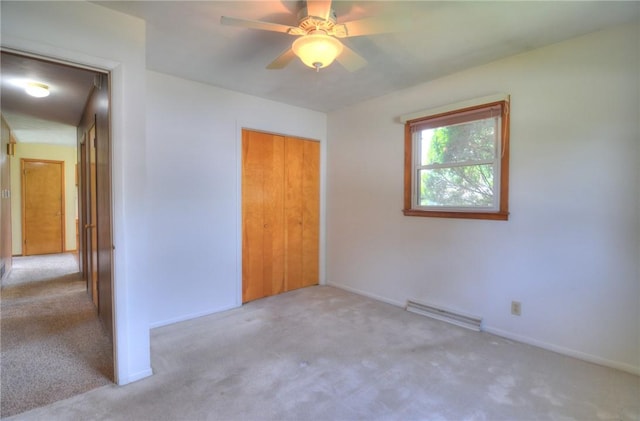 635 E N St, Warrensburg, IL 62573 - unfurnished bedroom with carpet floors, a closet, baseboards, and a baseboard radiator