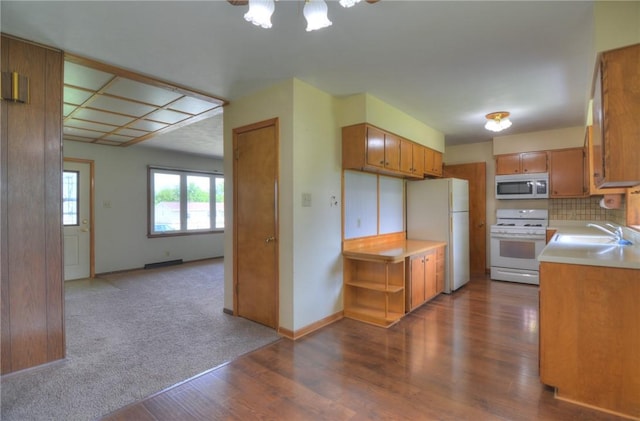 635 E N St, Warrensburg, IL 62573 - kitchen with white appliances, a sink, light countertops, dark wood-type flooring, and brown cabinets