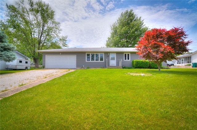 635 E N St, Warrensburg, IL 62573 - ranch-style house featuring a front yard, driveway, and a garage