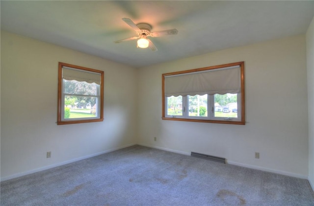 635 E N St, Warrensburg, IL 62573 - carpeted empty room with healthy amount of natural light, ceiling fan, and baseboards