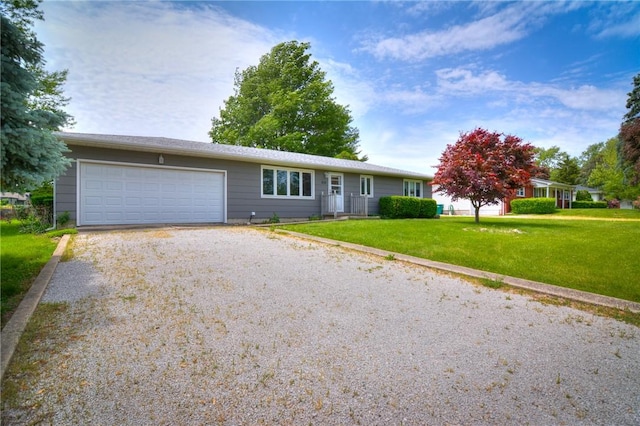635 E N St, Warrensburg, IL 62573 - single story home featuring gravel driveway, an attached garage, and a front yard