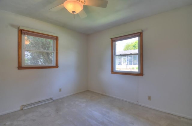 635 E N St, Warrensburg, IL 62573 - empty room featuring carpet floors, baseboards, a ceiling fan, and baseboard heating