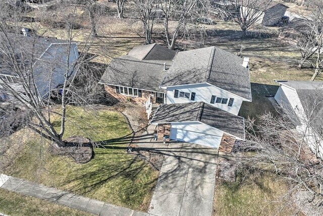 split level home featuring a garage and a front lawn