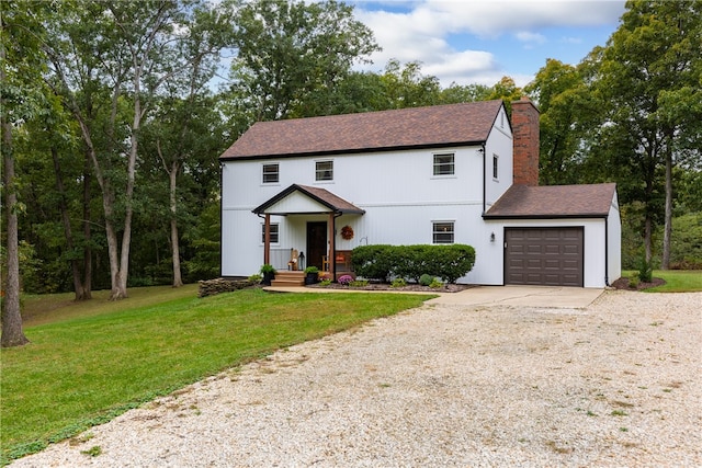 view of front of house with a front yard and a garage