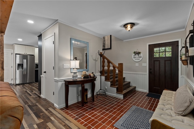 foyer with dark hardwood / wood-style floors and ornamental molding