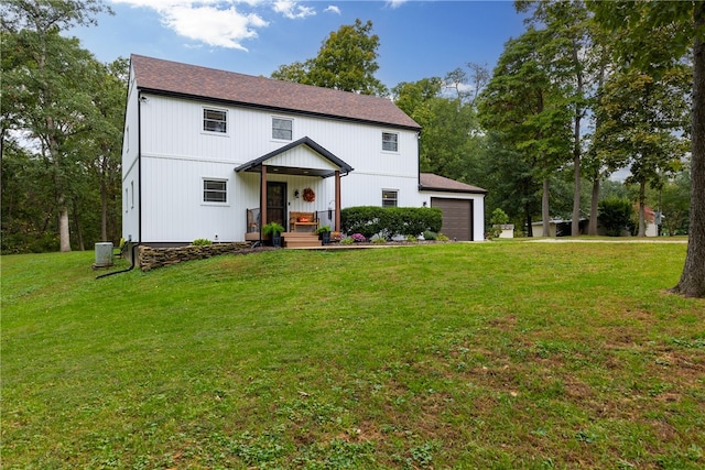 modern farmhouse featuring a front yard and a garage