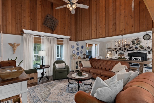 living room featuring a fireplace, wood walls, plenty of natural light, and hardwood / wood-style flooring