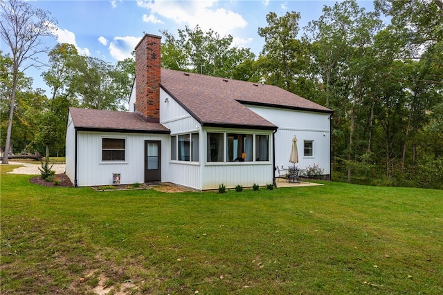 back of property featuring a patio area, a sunroom, and a yard