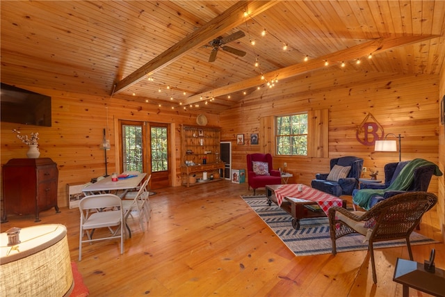 living room featuring vaulted ceiling with beams, light hardwood / wood-style flooring, ceiling fan, and wooden ceiling