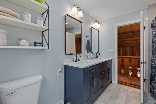 bathroom featuring toilet, tile patterned flooring, vanity, and ornamental molding