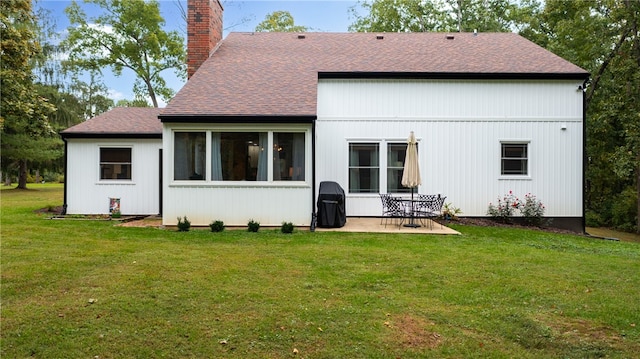 back of property featuring a lawn and a patio area