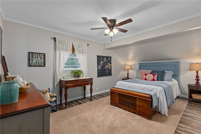 bedroom with hardwood / wood-style flooring, ceiling fan, and crown molding