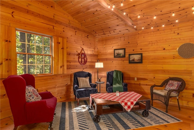 sitting room with hardwood / wood-style floors, wood walls, wood ceiling, and high vaulted ceiling