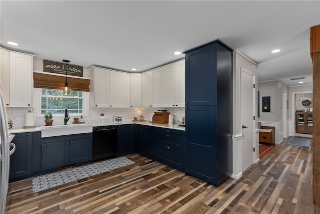 kitchen featuring dishwasher, sink, tasteful backsplash, dark hardwood / wood-style flooring, and decorative light fixtures