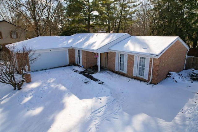 single story home with an attached garage and brick siding