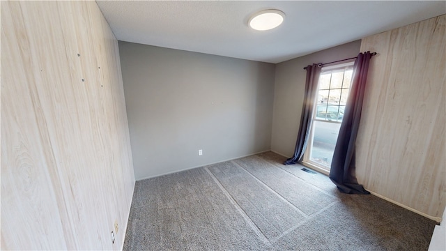 spare room featuring carpet and visible vents