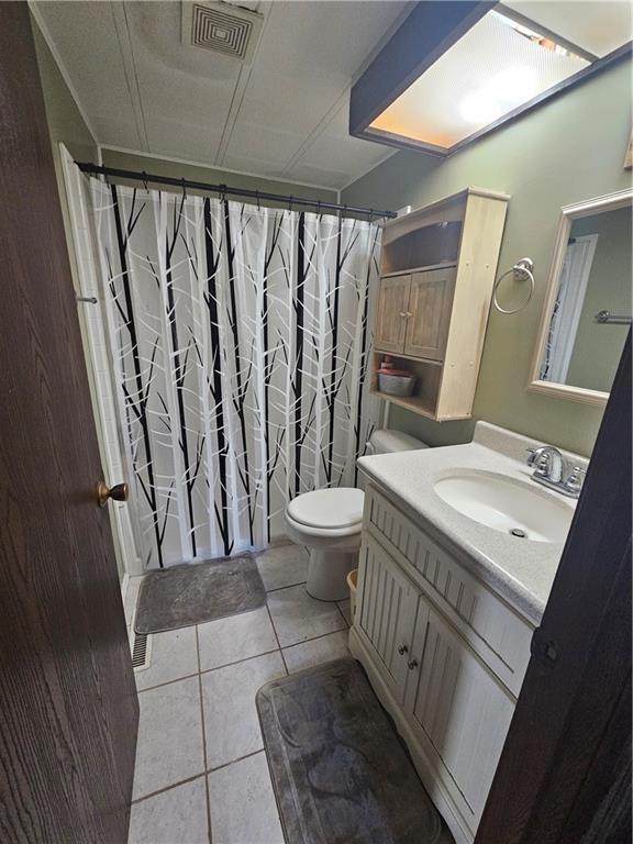 bathroom with tile patterned floors, vanity, and toilet