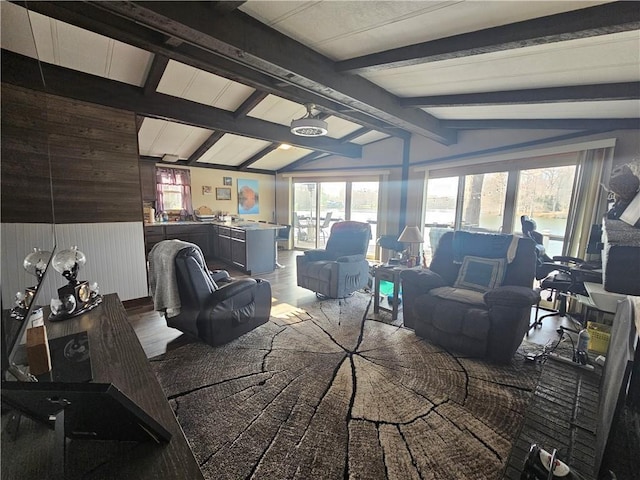 living room with wood walls and lofted ceiling with beams