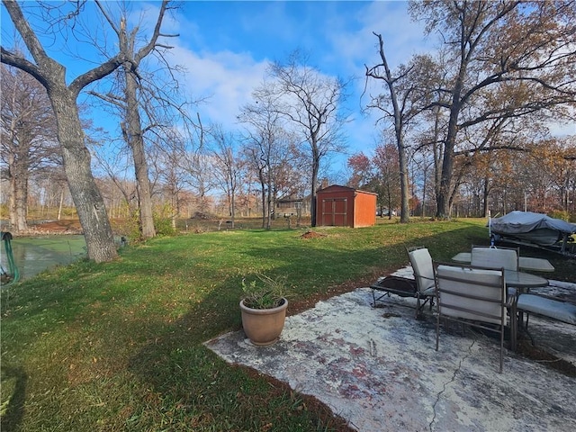 view of yard featuring a storage unit and a patio area