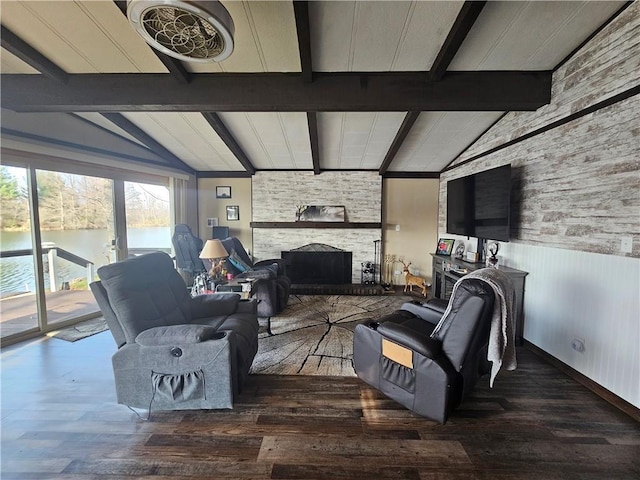 living room with a fireplace, a water view, lofted ceiling with beams, and wood-type flooring