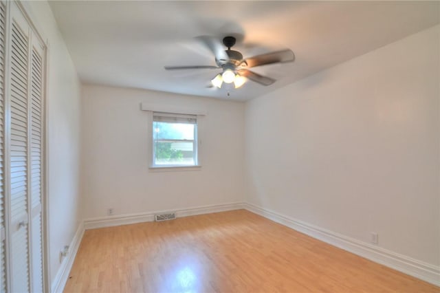 235 W Lawrence St, Illiopolis, IL 62539 - empty room with light wood-style floors and a ceiling fan