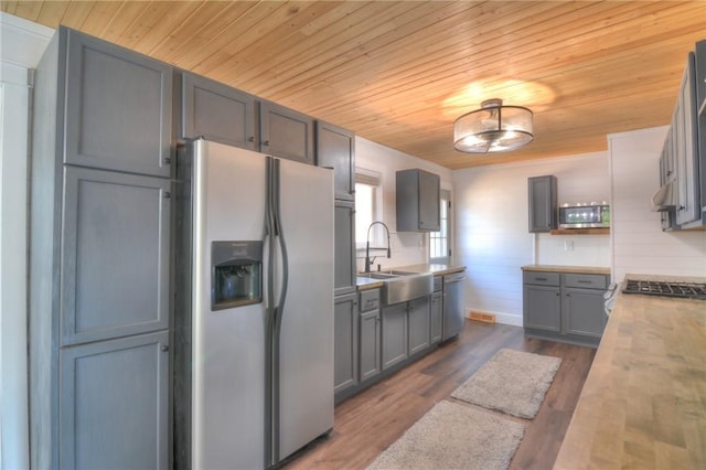 235 W Lawrence St, Illiopolis, IL 62539 - kitchen with stainless steel appliances, wood ceiling, light countertops, dark wood-type flooring, and gray cabinetry