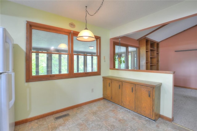 interior space with baseboards, visible vents, and lofted ceiling