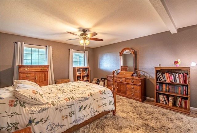 5334 Blue Mound Rd, Macon, IL 62544 - bedroom with a textured ceiling, carpet floors, a textured wall, a ceiling fan, and beam ceiling