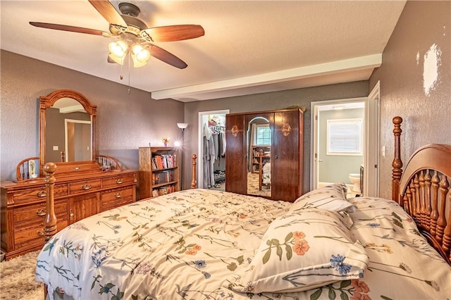 5334 Blue Mound Rd, Macon, IL 62544 - bedroom featuring a walk in closet, a closet, a textured wall, connected bathroom, and a ceiling fan