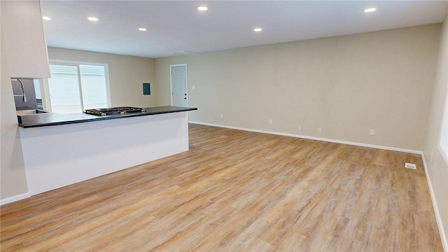 kitchen featuring stainless steel gas cooktop, recessed lighting, and light wood finished floors