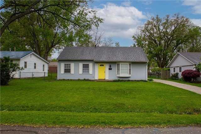 view of front of house with a front lawn and fence