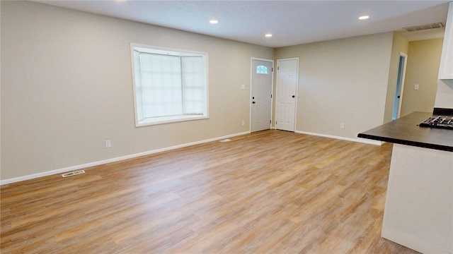 interior space with visible vents, recessed lighting, baseboards, and light wood finished floors