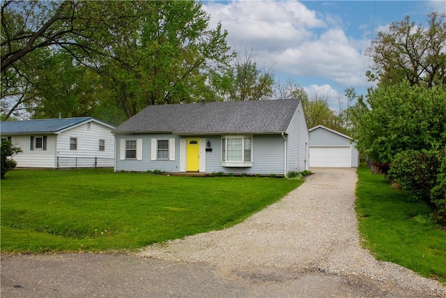 single story home featuring a garage, fence, an outbuilding, and a front yard