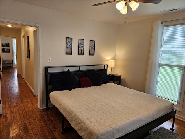 bedroom featuring dark wood-style floors, baseboards, and ceiling fan
