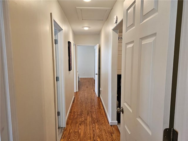 hall with wood finished floors and baseboards