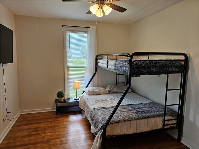 bedroom featuring wood finished floors, baseboards, and ceiling fan
