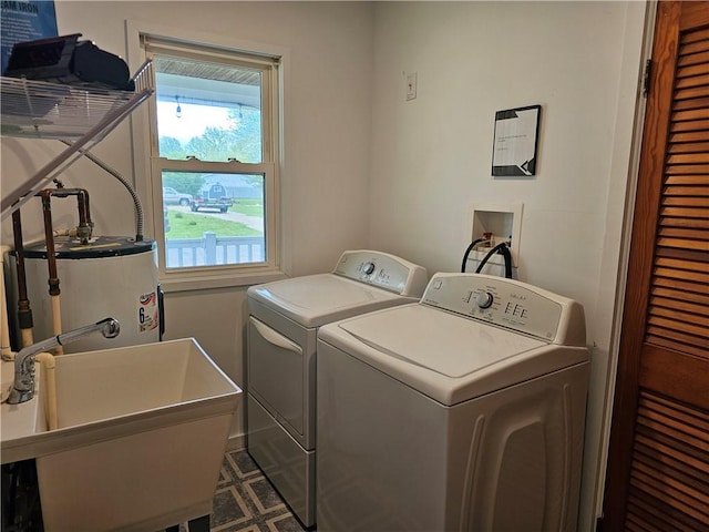 washroom with washer and dryer and water heater
