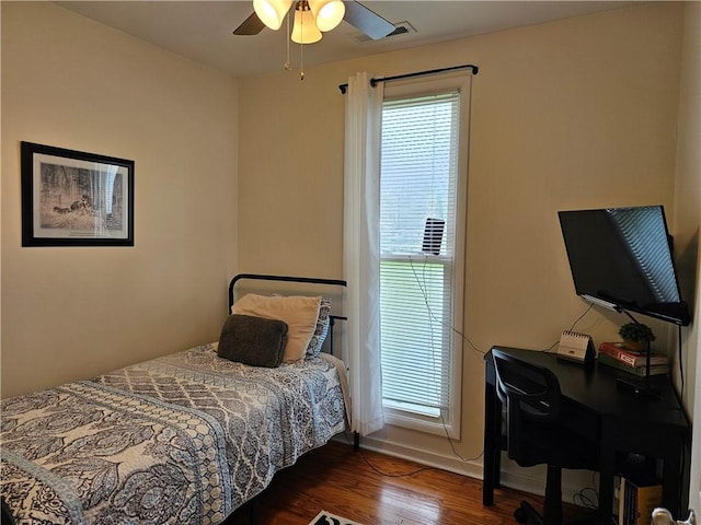 bedroom featuring wood finished floors, ceiling fan, an office area, and baseboards