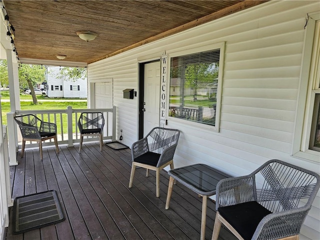 wooden terrace featuring covered porch